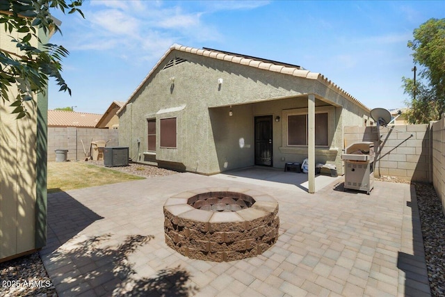 5026 S 235th Dr, Buckeye, AZ 85326 - rear view of house featuring stucco siding, an outdoor fire pit, a patio area, and a fenced backyard