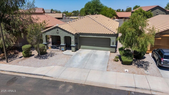 5026 S 235th Dr, Buckeye, AZ 85326 - mediterranean / spanish house with a tiled roof, a garage, driveway, and stucco siding