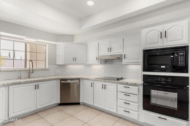 kitchen with white cabinets, a sink, black appliances, and light stone countertops