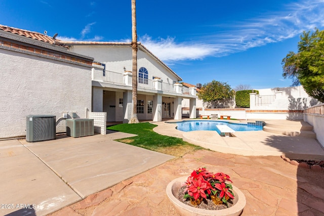 view of swimming pool with a patio, a fenced backyard, a fenced in pool, and central air condition unit