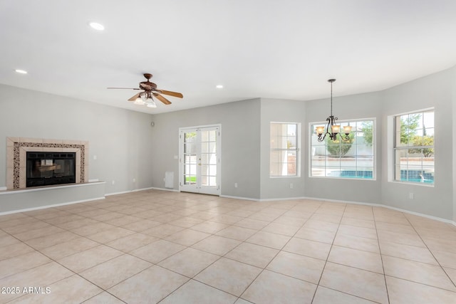 unfurnished living room featuring a glass covered fireplace, french doors, baseboards, and recessed lighting