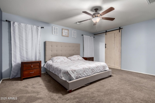 bedroom featuring visible vents, a ceiling fan, a barn door, carpet, and baseboards