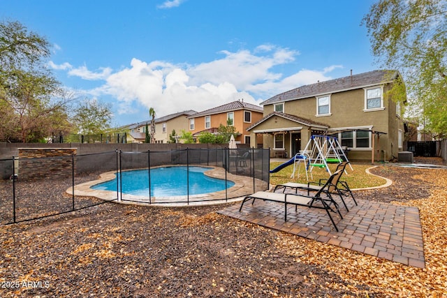 view of pool with a fenced in pool, a fenced backyard, central AC, a patio area, and a residential view