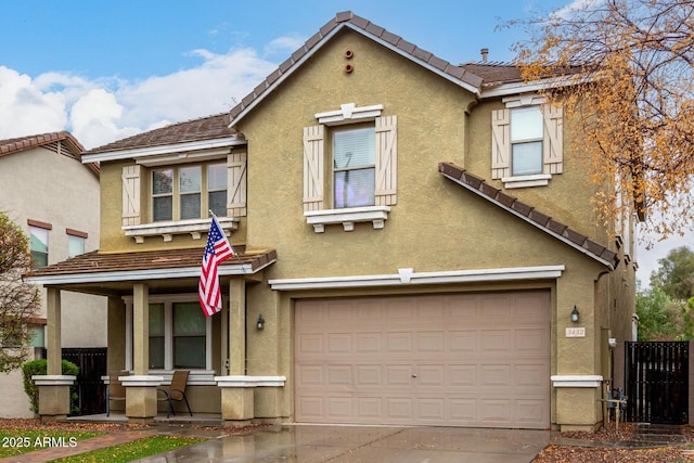 multi unit property with covered porch, stucco siding, a tile roof, and a garage