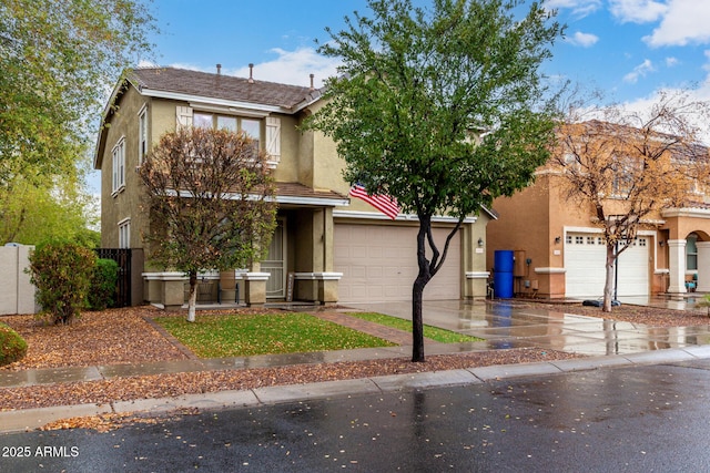 townhome / multi-family property with stucco siding, concrete driveway, and fence