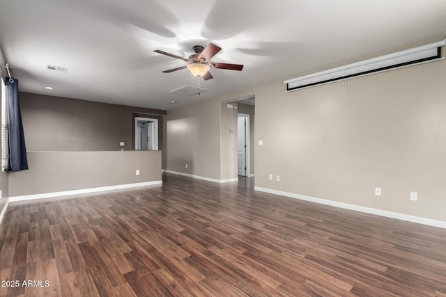 empty room with ceiling fan, visible vents, baseboards, and wood finished floors