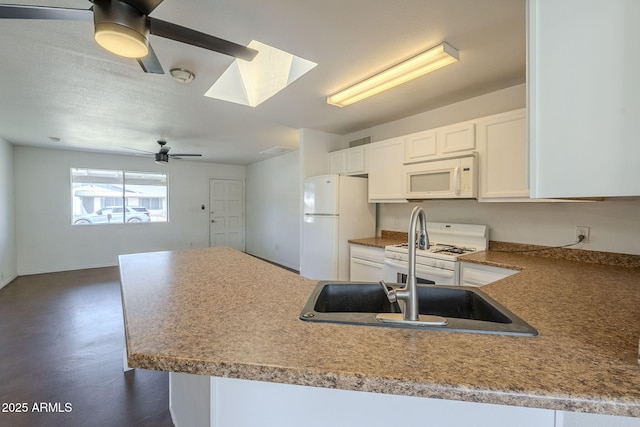 7737 W Medlock Dr, Glendale, AZ 85303 - kitchen with white appliances, a peninsula, a sink, ceiling fan, and white cabinets