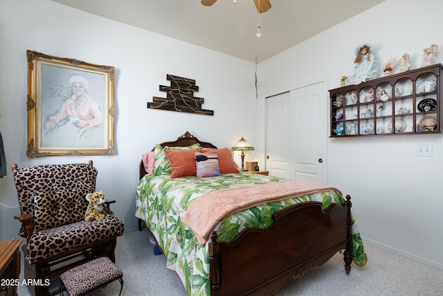 carpeted bedroom with a closet, ceiling fan, and baseboards