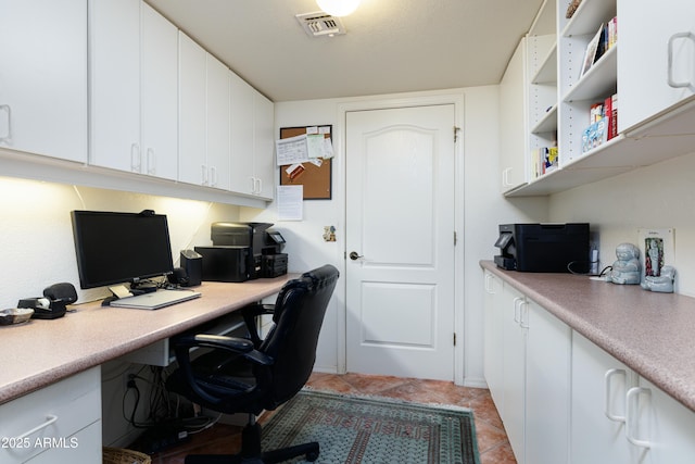 office area featuring light tile patterned floors and visible vents