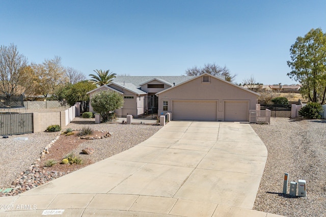 ranch-style home featuring driveway, a fenced front yard, an attached garage, and stucco siding