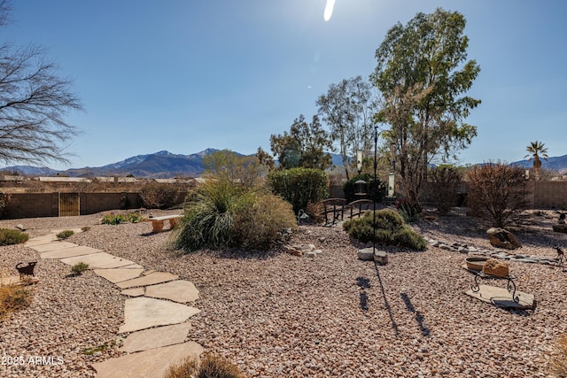 view of yard with fence and a mountain view