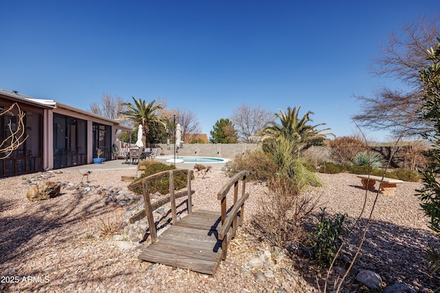 view of yard with a fenced in pool, a sunroom, a patio, and fence