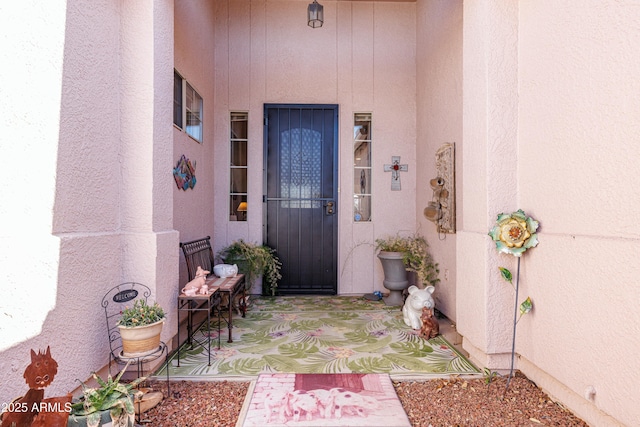 property entrance with stucco siding