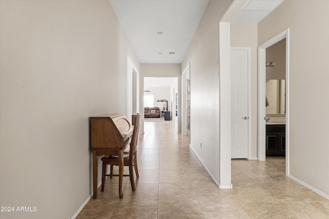 hall with light tile patterned floors