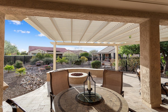 view of patio featuring outdoor dining space, a fire pit, a fenced backyard, and a pergola