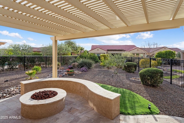 view of patio / terrace with a fire pit, a fenced backyard, and a pergola