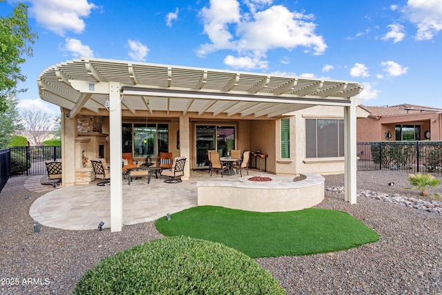 rear view of house with stucco siding, a patio area, a pergola, and fence