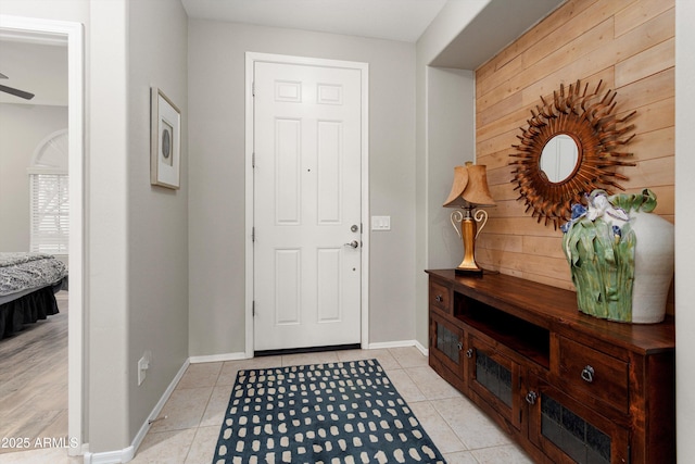 foyer featuring light tile patterned floors and baseboards