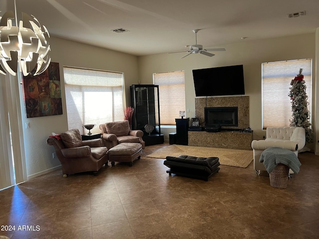 living room featuring ceiling fan and a fireplace