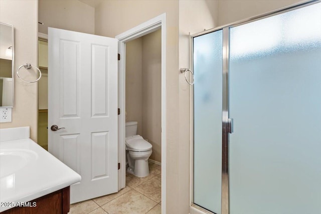 bathroom with walk in shower, tile patterned floors, vanity, and toilet