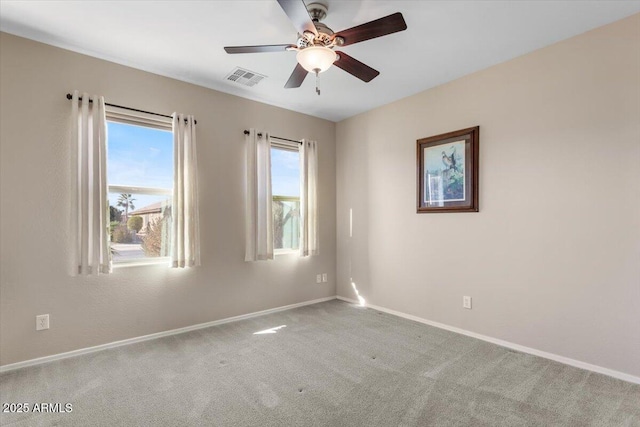 unfurnished room with ceiling fan, a healthy amount of sunlight, and carpet flooring