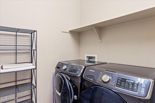 clothes washing area with washer and dryer