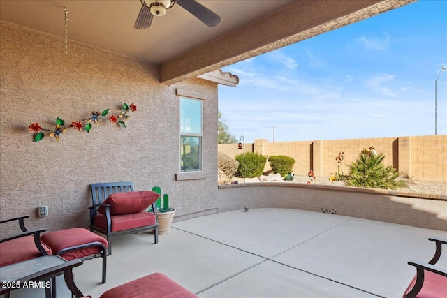 view of patio featuring ceiling fan