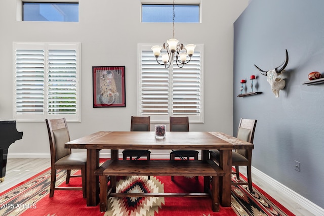 4976 E Thunderbird Dr, Chandler, AZ 85249 - dining area featuring a chandelier, wood finished floors, healthy amount of natural light, and baseboards