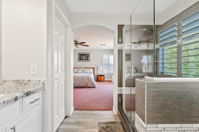 4976 E Thunderbird Dr, Chandler, AZ 85249 - full bathroom with wood finished floors, a stall shower, vanity, a ceiling fan, and ensuite bath