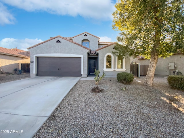 mediterranean / spanish house with a garage