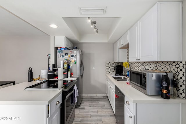 2514 N 22nd Ave, Phoenix, AZ 85009 - kitchen featuring black range with electric stovetop, dishwashing machine, light wood finished floors, backsplash, and stainless steel microwave