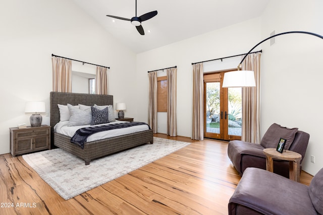 bedroom with light hardwood / wood-style floors, high vaulted ceiling, ceiling fan, french doors, and access to outside