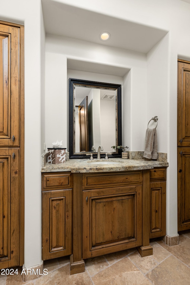 bathroom featuring tile floors and vanity