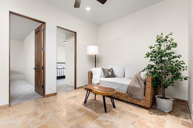 sitting room featuring ceiling fan and light tile floors