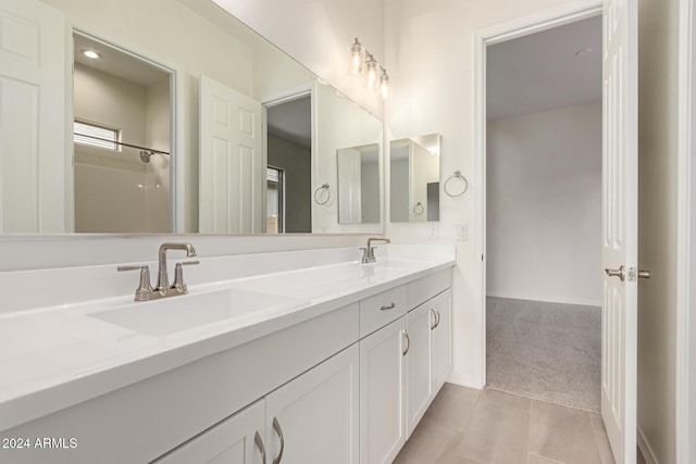 bathroom featuring tile patterned flooring and vanity