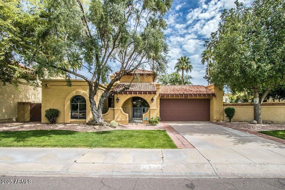 mediterranean / spanish home featuring a garage