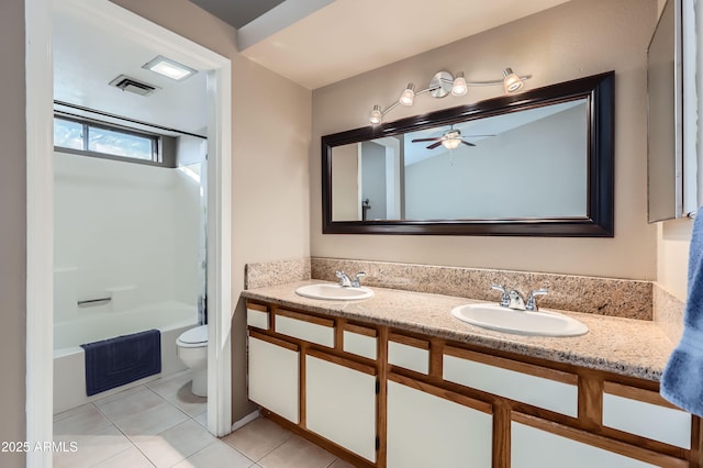 full bathroom featuring tile patterned floors, washtub / shower combination, vanity, toilet, and ceiling fan