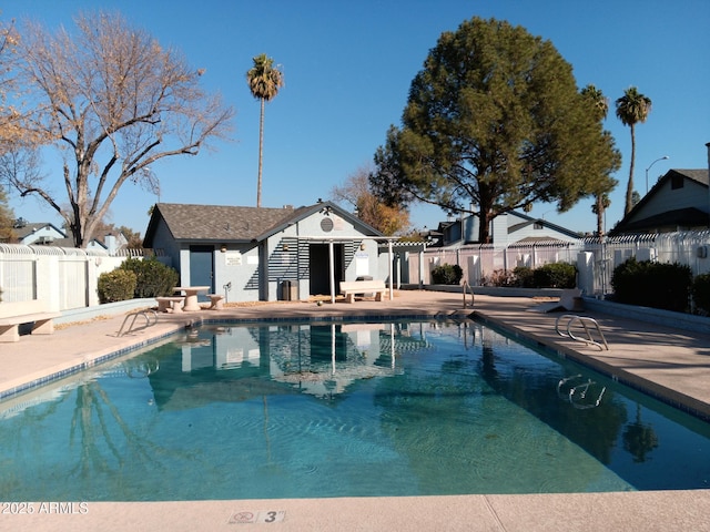 view of swimming pool featuring a patio and an outdoor structure