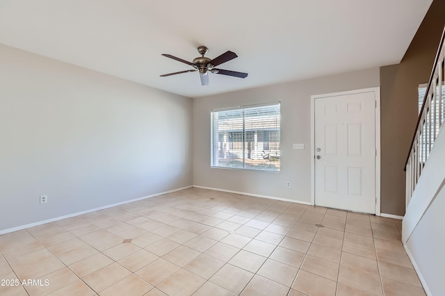 tiled spare room featuring ceiling fan