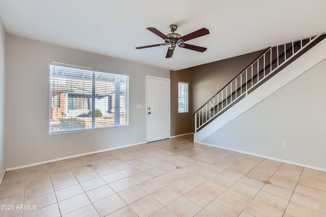 tiled entryway featuring ceiling fan