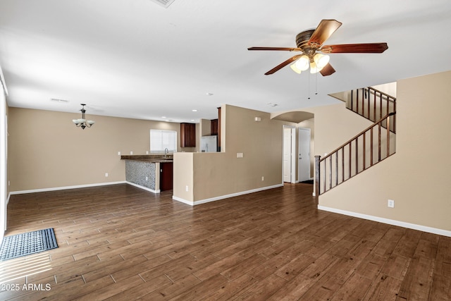 unfurnished living room with ceiling fan, dark wood-type flooring, and sink