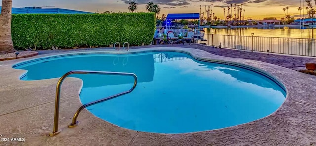 view of pool at dusk