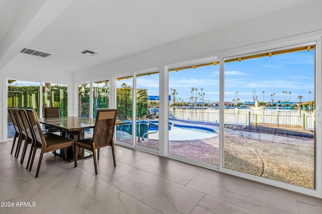 sunroom with a water view