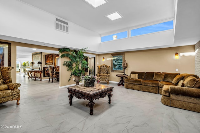 living room with plenty of natural light and a towering ceiling