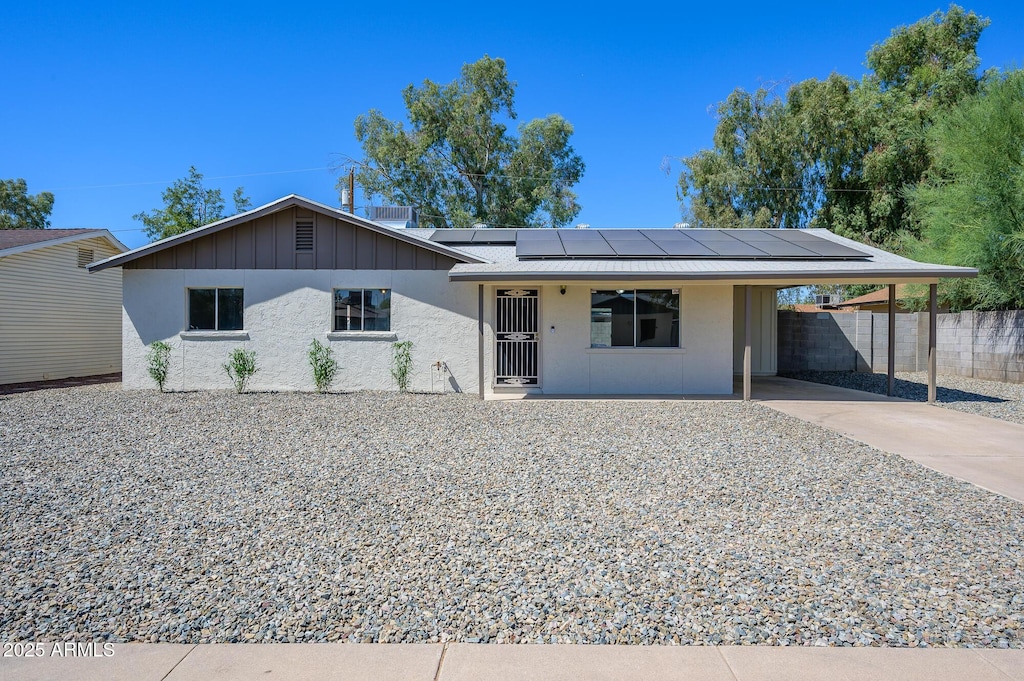 ranch-style home with solar panels