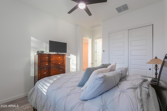 bedroom featuring ceiling fan, a closet, and hardwood / wood-style floors