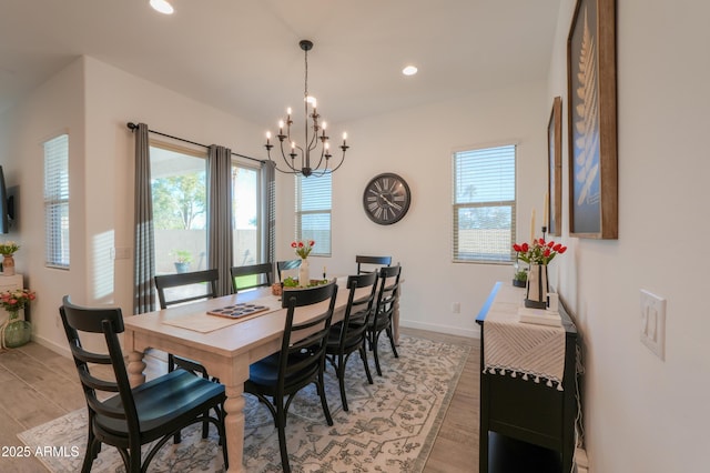 dining room with an inviting chandelier and light hardwood / wood-style flooring