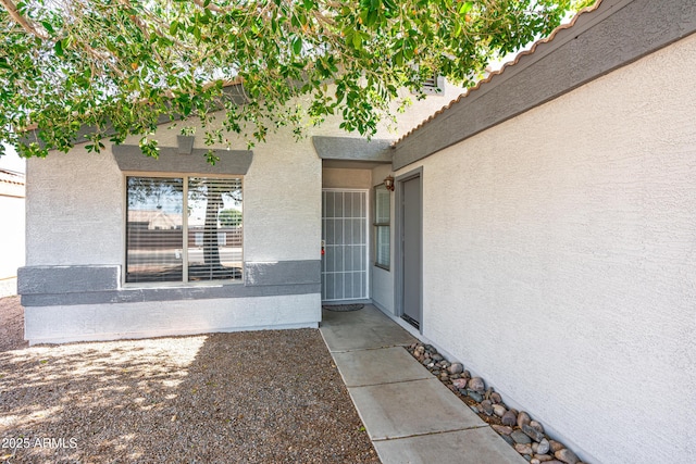 doorway to property with stucco siding