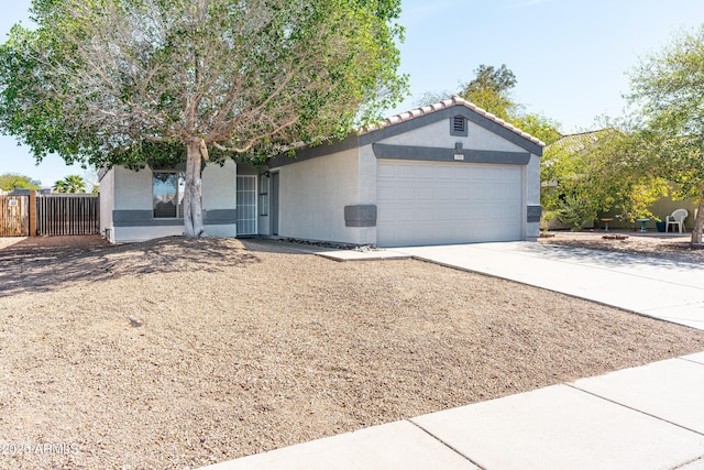 single story home with concrete driveway, an attached garage, and stucco siding