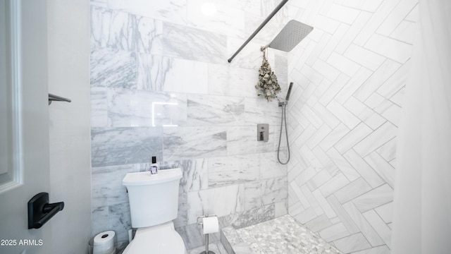 bathroom with tiled shower and toilet